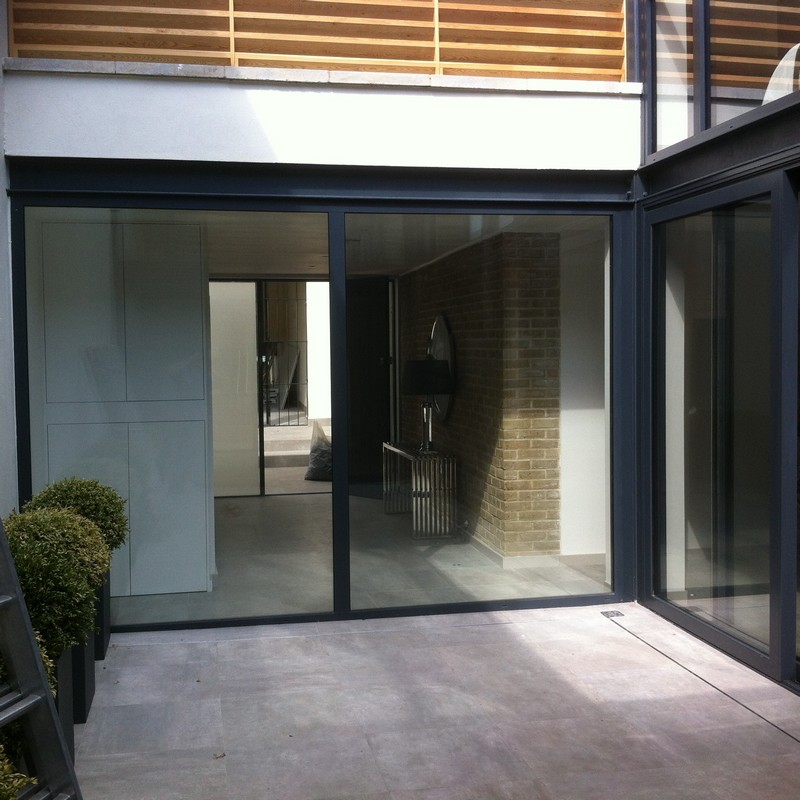 Floor-to-ceiling sliding doors opening to courtyard in Wokingham
