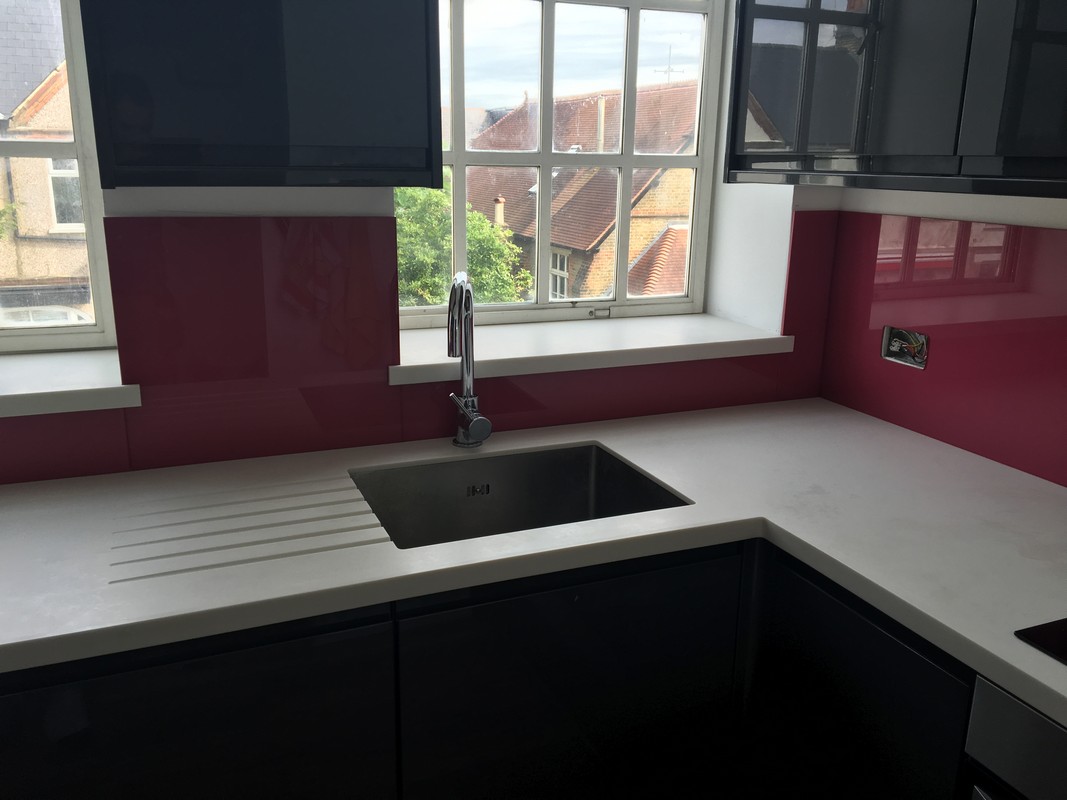 Deep plum coloured glass splashback in modern Wokingham kitchen
